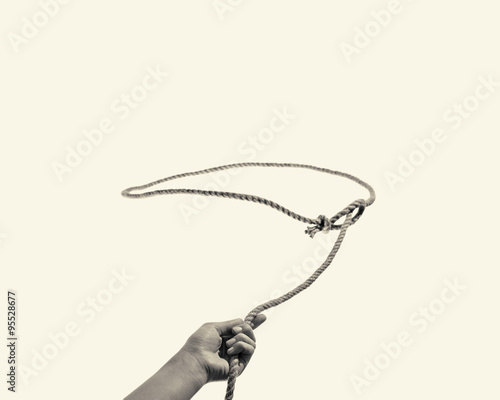 Fotomural The hand throws a lasso on toned background