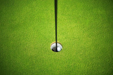 Golf Ball At The Hole