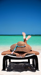 Wall Mural - Carefree young woman relaxing on tropical beach