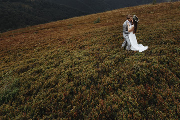 beautiful fabulous happy  bride and stylish groom on the backgro