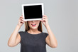 © Drobot Dean - Woman covering her eyes with blank tablet computer screen