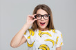 © Drobot Dean - Cheerful female teenager in glasses looking at camera