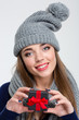 © Drobot Dean - Happy woman with scarf and hat holding jewelry gift box