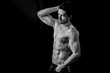 Handsome muscular man in black and white posing shirtless 