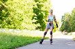 © Syda Productions - happy young woman in rollerblades riding outdoors