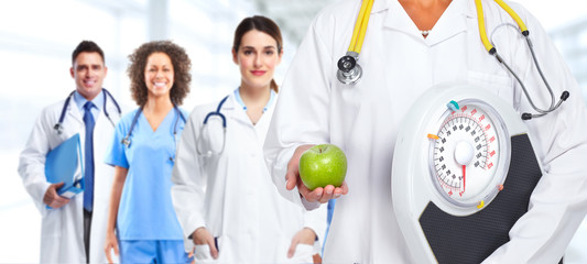 Poster - Doctor woman hands with scales and apple.