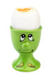 A green egg-cup with a painted face and a cooked soft-boiled egg isolated on white background.