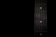 © Gpeg26 - guitar neck isolated on black background, horizontal view, low key image