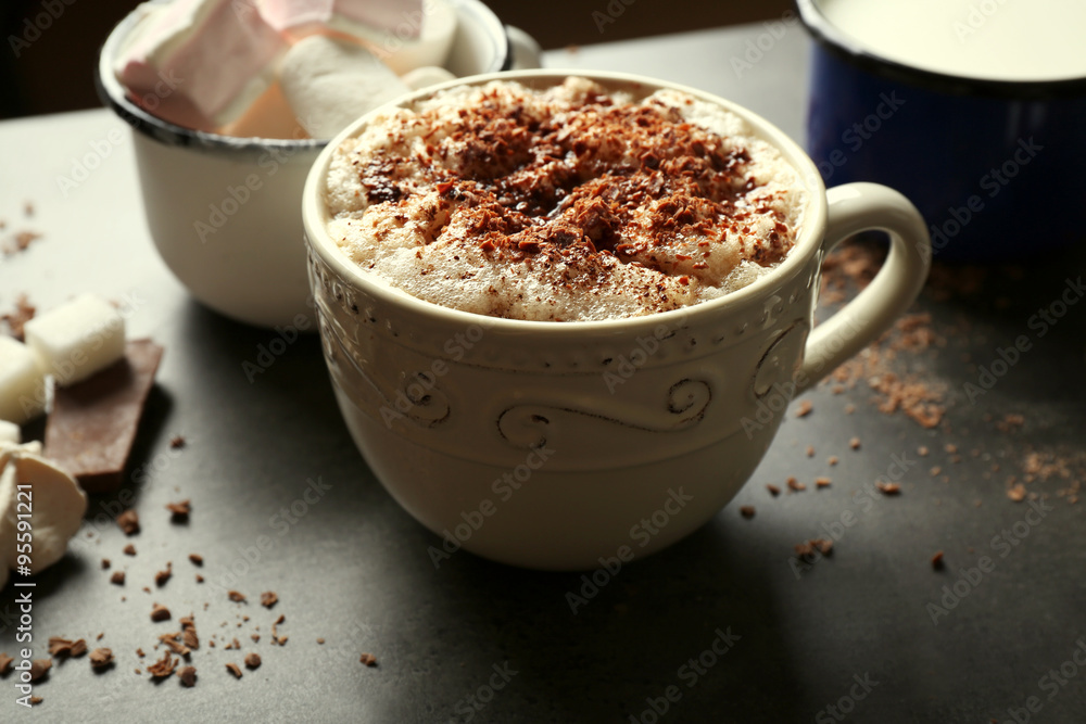 Cup of coffee with milk on a wooden table closeup