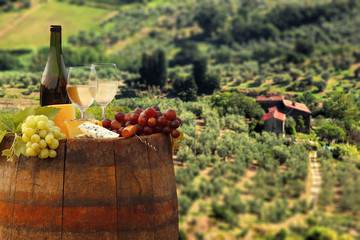 White wine with barrel on vineyard in Chianti, Tuscany, Italy