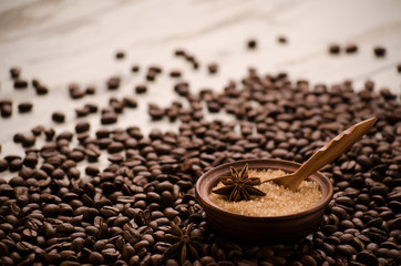 Sugar in a porringer stands on a table on grains of coffee