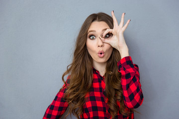 Sticker - Funny curly girl showing okay gesture near her eye