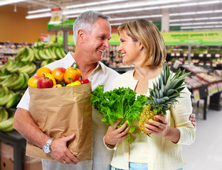 Wall Mural - Senior couple with grocery bag of vegetables.