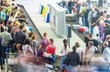 © Konstantin Yolshin - Lots of people getting luggage at airport.