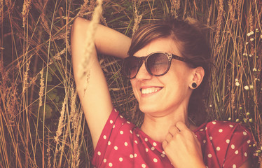 Girl relaxing in a wheat-field