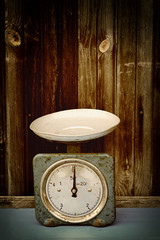 antique scales on the old wooden background vintage retro