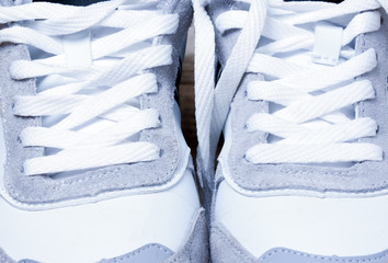 sneakers laced white laces closeup.background