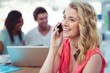 © WavebreakMediaMicro - Smiling creative businesswoman working with co-workers