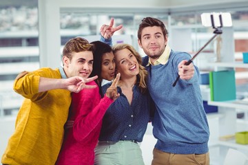 Wall Mural - Smiling creative team posing for a selfie