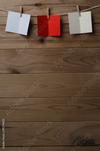 Three Opened Greetings Cards Pegged To String On Wood Planking