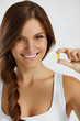 Nutrition. Healthy Lifestyle. Woman Holding Pill With Fish Oil Omega-3. Supplements, Vitamins.