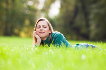 Wall Mural - Happy woman relaxing and enjoying nature in park