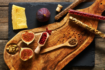 Wall Mural - Olive wood cutting board with spices and fig