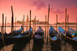 Venice with famous gondolas at gentle pink sunrise light,