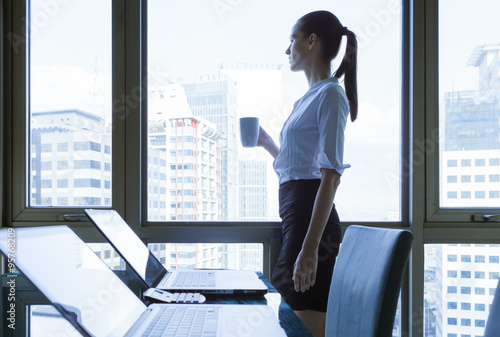 Fényképezés  Business woman looking out the window
