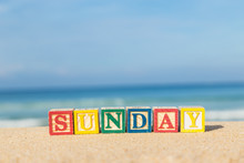 Word SUNDAY In Colorful Alphabet Blocks On Tropical Beach