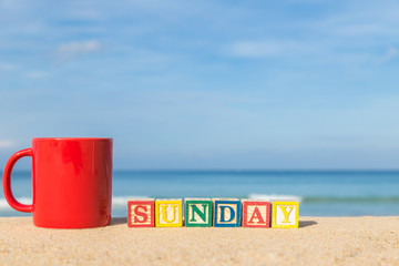 Wall Mural - word SUNDAY in colorful alphabet blocks and coffee cup on tropic