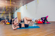 © satyrenko - People at the health club with personal trainer, learning correct form