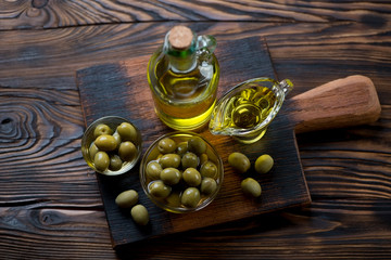 Wall Mural - Olive oil and green olives, high angle view, studio shot