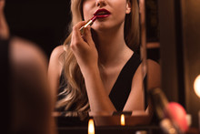 Flirtatious Female Using Red Lipstick