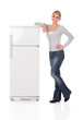 Woman Leaning On Refrigerator Over White Background