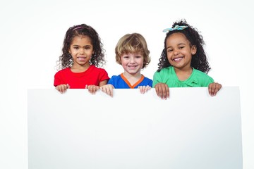 Wall Mural - Three kids holding a large white sheet