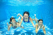 © Iuliia Sokolovska - Family swim in pool underwater, happy active mother and children have fun in water, kids sport on family vacation