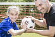 © Louis-Photo - teenager girl with his father play soccer in a beautiful day