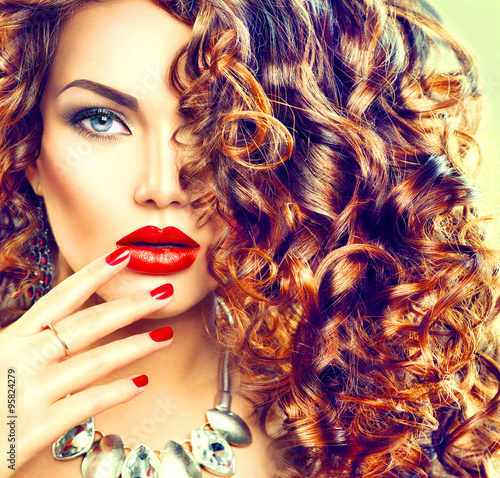 Obraz w ramie Beauty young brunette woman with curly hair, perfect makeup and manicure