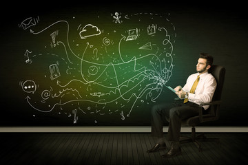 Poster - Businessman sitting in chair holding tablet with media icons