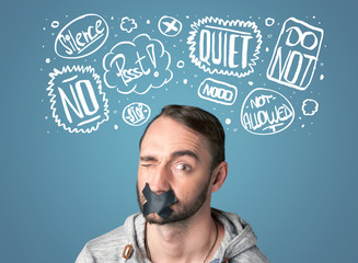 Young man with glued mouth and thought clouds