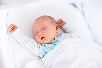 Wall Mural - cute newborn baby in white bed