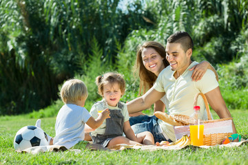 Wall Mural - Family of four having picnic