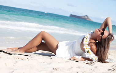 Wall Mural - Happy beautiful woman enjoying sunlight at beach.