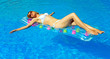 © M-Production - Pretty woman relaxing in swimming pool. Place for text.