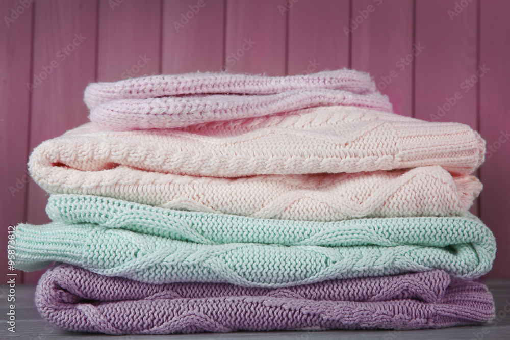 Hand made clothes on wooden wall background