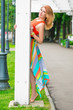 © kosmos111 - beautiful girl peeping from behind pillar gazebo in the park