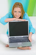 © very_ulissa - beautiful woman at home pointed on screen of laptop