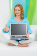 © very_ulissa - beautiful woman at home pointed on screen of laptop