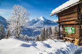 Fototapeta Do pokoju - Winter wonderland in the Alps with traditional mountain chalet